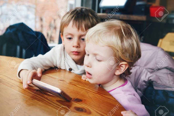 Portrait De Deux Enfants Tout-Petits Garçon Et Une Fille Jouant Téléphone  Cellulaire Jeux De Tablettes, Regarder Des Dessins Animés Film, Assis À avec Tout Les Jeux De Fille Et De Garcon